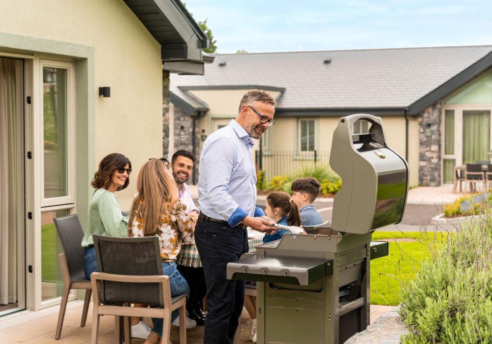 External, grandfather cooking a family BBQ at The Lodges