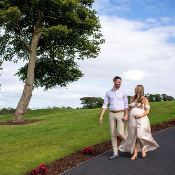 Expectant couple walking around the estate